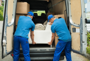 men doing a sofa removal in a van